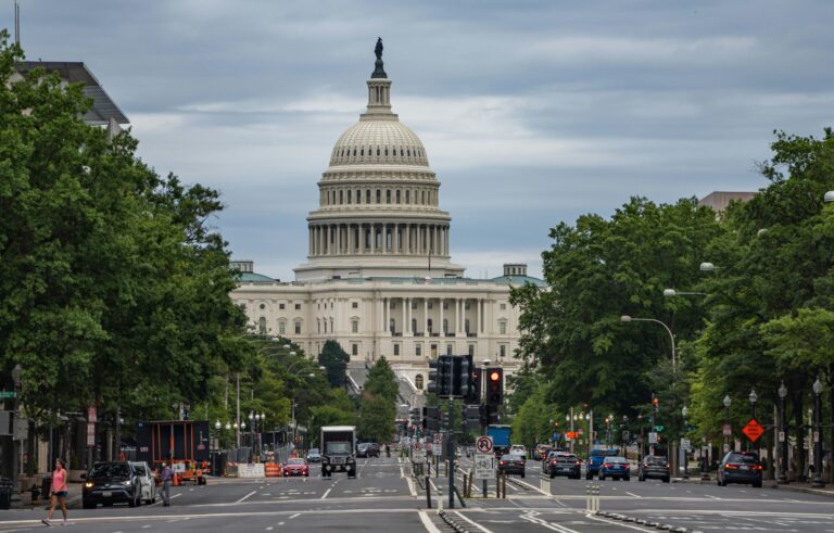 pedestrians walking in road in front of U.S. capitol building