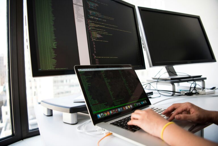 shallow focus picture of person using macbook